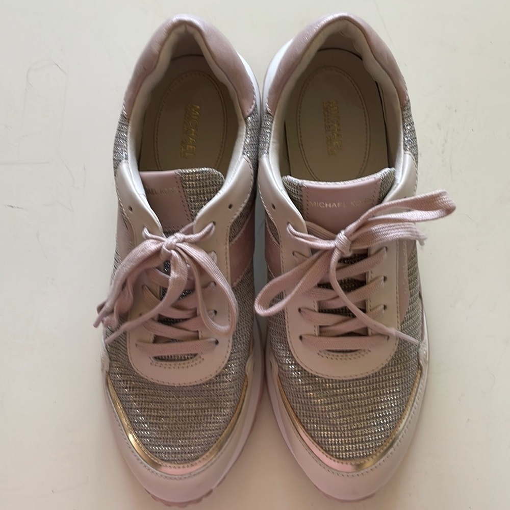 Blush pink Michael Kors sneakers with silver bling detailing with gold trim.